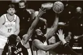  ?? Mark J. Terrill / Associated Press ?? The Nets’ James Harden, center, powered through the Clippers’ defense for 37 points and 11 rebounds.