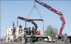  ??  ?? Preparing the travel crate for the elephant’s transport