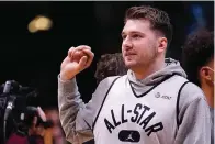  ?? The Associated Press ?? Dallas Mavericks forward Luka Doncic sets to throw a souvenir to fans during a practice session for the NBA All-Star game in Cleveland Saturday.