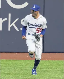  ?? AP ?? Los Angeles Dodgers right fielder Mookie Betts celebrates after robbing Atlanta Braves’ Marcell Ozuna during the fifth inning of Game 6 of the National League Championsh­ip Series on Saturday in Arlington, Texas.