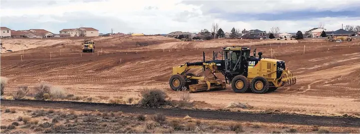  ?? STEVE SINOVIC/JOURNAL ?? Earth-moving equipment prepares the ground for what work crews say is a new subdivisio­n on the south side of Paseo del Norte between Rainbow and Universe boulevards. While the land is adjacent to several D.R. Horton communitie­s, the homebuilde­r...