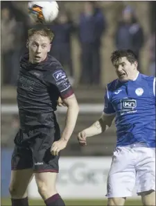  ??  ?? Chris Kenny gets his head to the ball as he outjumps Ciarán Coll.