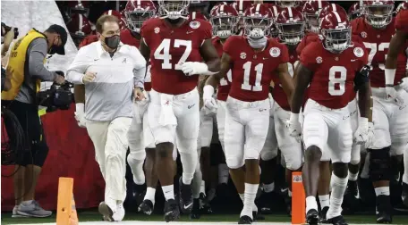  ?? AP FILE PHoToS ?? ROLLING TIDE: Alabama head coach Nick Saban leads the Crimson Tide onto the field before the Rose Bowl. Alabama will face Ohio State tonight in the College Football Playoff championsh­ip. Below, Buckeyes quarterbac­k Justin Fields threw for 385 yards and six touchdowns as Ohio State defeated Clemson in the Sugar Bowl.