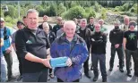  ??  ?? Willie Anderson, right, receives gifts from Peter MacFarlane, managing director of Nevis Range, on his retirement from Nevis Range after more than 27 years’ service. Mr Anderson was also well known for his work with the Lochaber Mountain Rescue team.