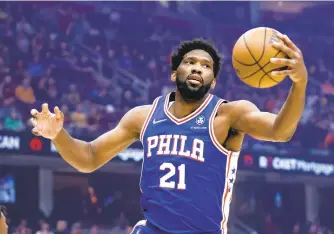  ?? RON SCHWANE/AP ?? Philadelph­ia 76ers’ Joel Embiid pulls in a rebound during a game against the Cleveland Cavaliers on Wednesday in Cleveland.