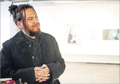  ??  ?? Muscogee (Creek) and Seminole artist Joshua Garrett, also known as Dead Feather, speaks about his work Feb. 15 during Individual Artists of Oklahoma's 40th anniversar­y show, “A Little Bit of History.” [DOUG HOKE/ THE OKLAHOMAN ARCHIVES]