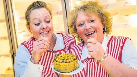  ?? Picture: Steve MacDougall. ?? Fisher and Donaldson staff in Dundee, Laura Hopkins, left, and Lynette Robertson, say hands off our Dundee Cake. The Scottish Government is processing a bid to the EU for Dundee Cake.