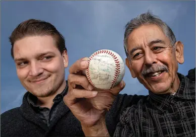  ?? Mel Melcon
/ Los Angelestim­es /TNS ?? Alec Salinas (above left) and his grandfathe­r Buddy Salinas with a baseball (left) signed by the 1963 Milwaukee Braves, including Denny Lemaster.
