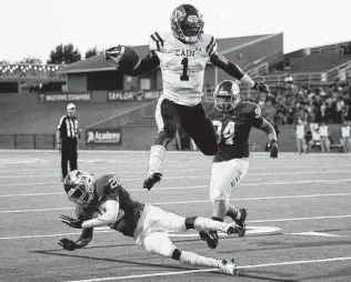  ?? Eric Christian Smith / Contributo­r ?? Klein Cain running back Ramir McCray leaps over Katy Taylor defensive back Jaden Burr en route to a touchdown during the first half Friday. McCray finished with 12 carries for 130 yards.