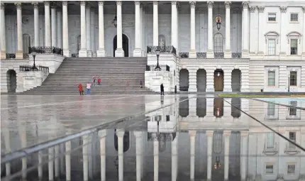  ?? WIN MCNAMEE/GETTY IMAGES ?? The pain of a partial government shutdown may become more pronounced as people return from holiday breaks this month. Congress is set to come back to the Capitol on Thursday to renew the funding feud.