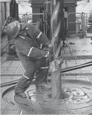  ?? ASSOCIATED PRESS FILES ?? An oil worker handles a drill on the Centenario deepwater drilling platform off the coast of Veracruz. Mexico is opening its oil industry to private and foreign investment.