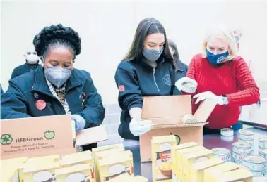  ?? ELIZABETH CONLEY/HOUSTON CHRONICLE ?? Democratic Reps. Sheila Jackson Lee of Texas, left, Alexandria Ocasio-Cortez of New York and Sylvia Garcia of Texas distribute food Saturday at the Houston Food Bank in Texas, which is recovering from extreme weather.