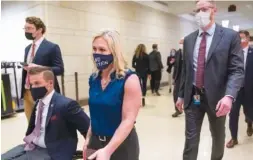  ?? AP PHOTO/J. SCOTT APPLEWHITE ?? Rep. Marjorie Taylor Greene, R-Ga., walks with fellow House Republican­s on Capitol Hill in Washington on Wednesday.