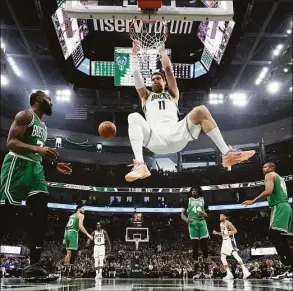  ?? Morry Gash / Associated Press ?? The Bucks’ Brook Lopez dunks during Game 3 of their playoff series on Saturday in Milwaukee.