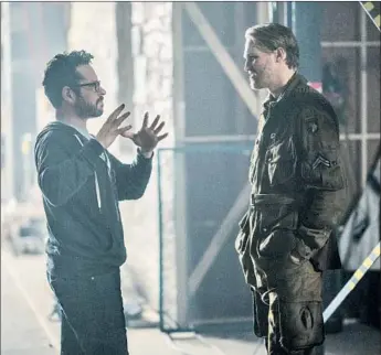  ?? Peter Mountain Paramount Pictures ?? PRODUCER J.J. Abrams, shown with actor Wyatt Russell on the set of “Overlord,” is in the advanced stages of negotiatio­ns with WarnerMedi­a, sources say. Multiple studios had been courting Abrams.