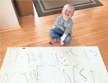  ?? SUBMITTED PHOTO ?? Walter Kanzenbach, 4, sits in front of a writing assignment, showing dump trucks in the forest.