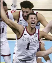  ?? ANDY LYONS — THE ASSOCIATED PRESS ?? Gonzaga’s Jalen Suggs celebrates with teammates after making a game-winning 3-point basket in overtime to defeat UCLA in Saturday’s game.
