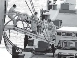  ?? CHARLES TRAINOR JR ctrainor@miamiheral­d.com ?? A patient is rolled off the Zaandam cruise ship at Port Everglades in Fort Lauderdale on April 2.