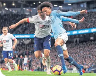  ??  ?? Leroy Sane holds of Bournemout­h’s Simon Francis