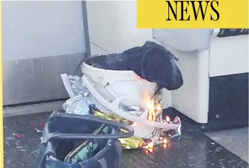  ?? AFP / GETTY IMAGES ?? A plastic bucket burns inside a London subway train on Friday. The bucket is believed to contain a bomb, packed with nuts, bolts and nails, used by terrorists that injured more than 20 train passengers. The main explosive charge failed to go off,...