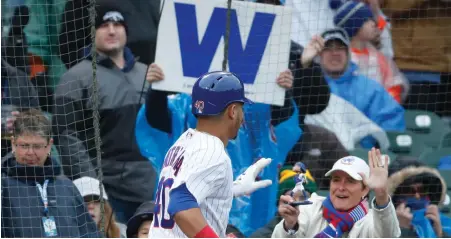  ?? AP PHOtO ?? SIGN OF THE TIMES: Willson Contreras celebrates in front of Cubs fans after belting a home run in yesterday’s 11-2 victory against their crosstown rival White Sox at Wrigley Field.