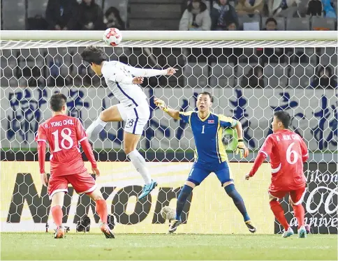  ?? — AFP photo ?? South Korean forward Jin Seonguk (2nd L) heads the ball during the men’s football match between South Korea and North Korea at the EAFF E-1 football championsh­ip in Tokyo on December 12, 2017.