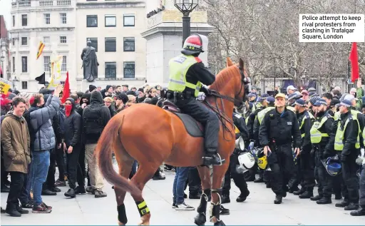  ??  ?? Police attempt to keep rival protesters from clashing in Trafalgar Square, London