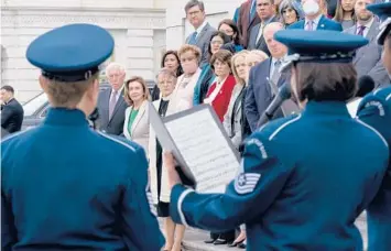  ?? J. SCOTT APPLEWHITE/AP ?? Members of the House stand on the steps of the U.S. Capitol on Thursday during a ceremony to honor the Americans who have died of COVID-19 as the number neared 1 million, a total reached Monday.