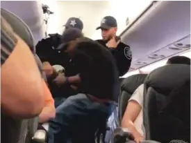  ?? | SUPPLIED PHOTO ?? Three Chicago Department of Aviation officers remove Dr. David Dao fromUnited Airlines Flight 3411 on April 9.