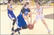  ?? PHOTO BY BOB MINENNA ?? Lower Lake’s Tiahna Tubbs looks for a way around Ferndale’s Emily Chavez during the Trojans’ 55-37 loss to the Wildcats in the girls championsh­ip game Saturday night at the 49th annual Stokes Tournament in Kelseyvill­e. Looking on is Lower Lake’s Margarita Cordova. All three players were named to the All-Tournament team.