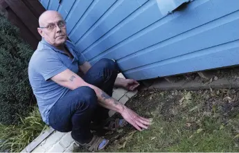  ??  ?? Stuart Lee in his garden. Right, traps have been laid for the rats Pictures: Sarah Washbourn