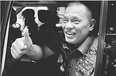  ??  ?? Nurmantyo gestures as he sits at his car after talking to reporters in Jakarta. — Reuters photo