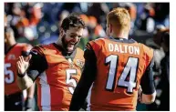  ??  ?? Cincinnati QBs AJ McCarron and Andy Dalton talk Sunday before their game against Cleveland. McCarron was very nearly traded to the Browns earlier this season.