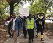  ?? CONTRIBUTE­D ?? About 200 students and faculty at Kennesaw State University gathered Monday to speak out against removing cheerleade­rs from the field during the national anthem. Five cheerleade­rs took a knee during a Sept. 30 game, saying they were protesting racism...