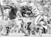  ?? AL DIAZ/MIAMI HERALD ?? Miami defensive lineman Demetrius Jackson, right, is one of the few returning D-line members on the ’Canes squad.