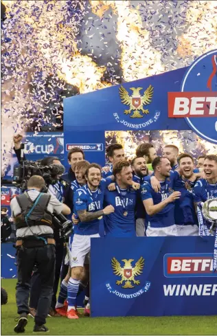  ??  ?? St Johnstone players celebrate, while right, boss Callum Davidson joins the party with his coaching staff