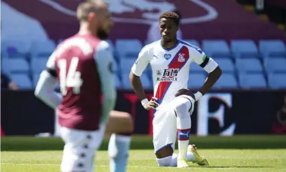  ??  ?? Wilfried Zaha takes a knee before Crystal Palace’s 2-0 defeat at Aston Villa. Photograph: Tim Keeton/AFP/Getty Images