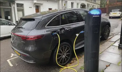 ?? (AP/Courtney Bonnell) ?? An electric vehicle charges at a public fast-charging station in London earlier this month.