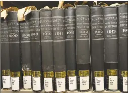  ??  ?? Volumes of the Norwalk Directory dating back to the 19th century in the basement-level Norwalk History Room of the Norwalk Library on Tuesday.