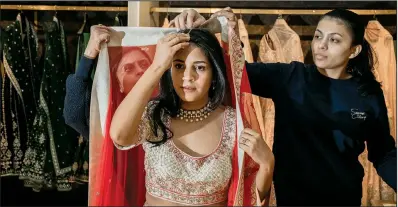  ?? (The New York Times/Natalie Keyssar) ?? Brianna Barzola, who is of Latin-American descent, recently visits the Indian designer Anita Dongre’s store to shop for lehengas for her two forthcomin­g wedding ceremonies, where she is to marry an Indian-American man.