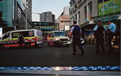  ?? Steven Saphore/AAP Image via Associated Press ?? Emergency services work the scene Saturday after multiple people were stabbed at the Westfield Bondi Junction shopping center in the Sydney suburbs. Six victims were killed and eight were injured before police fatally shot the attacker.