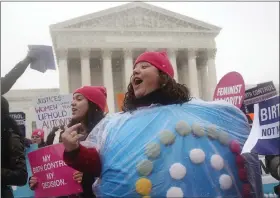  ?? AP FILE ?? Margot Riphagen of New Orleans, wears a birth control pill costume as she protests in front of the Supreme Court in Washington, D.C., in 2014. This year, a leaked draft opinion indicating U.S. Supreme Court justices are poised to overturn the decision that legalized abortion nationwide is raising fears that restrictio­ns on contracept­ion could follow.