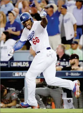  ?? ASSOCIATED PRESS ?? LOS ANGELES DODGERS’ YASIEL PUIG CELEBRATES after a single against the Arizona Diamondbac­ks during the fourth inning of Game 2 of the National League Division Series in Los Angeles on Saturday.