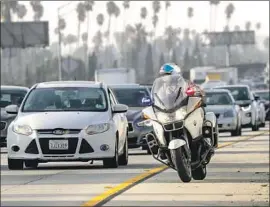  ?? Irfan Khan Los Angeles Times ?? THOSE WHO FACE losing their clean-air stickers say authoritie­s should go after carpool-lane cheaters like the one this CHP officer was headed for in 2017.