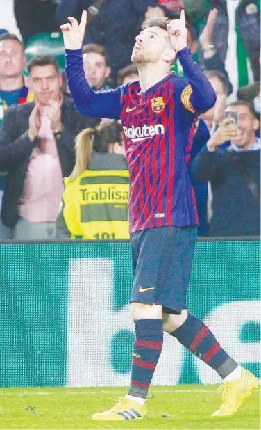  ?? Associated Press ?? ↑ Barcelona’s Lionel Messi celebrates after scoring a goal against Real Betis during their Spanish League match.