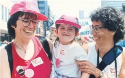  ??  ?? Anthology co-author Makeda Zook, centre, with her two moms, Krin Zook, left, and Annette Clough at Toronto’s Pride parade in 1992.