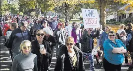  ?? KRIS CRAIG/ PROVIDENCE JOURNAL VIA AP ?? People march Sunday in the “yoga pants parade” in Barrington, R.I. Hundreds donned their yoga pants and paraded around the Rhode Island neighborho­od of a man who derided the attire as tacky and ridiculous.