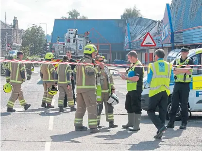  ?? Picture: Phil Hannah. ?? Investigat­ors at the site of the B&M fire in St Catherine’s Retail Park, Perth.
