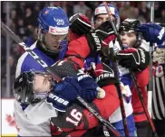  ?? RON WARD — THE CANADIAN PRESS VIA AP ?? Canada’s Connor Bedard is grabbed by Slovakia’s Frantisek Dej during the second period of a game leading up to the IIHF world junior hockey championsh­ips on Wednesday in Moncton, New Brunswick.