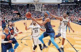  ?? [AP PHOTO] ?? Thunder forward Corey Brewer (3) goes to the basket in front of Pelicans forward Anthony Davis (23) in the second half of Oklahoma City’s 109-104 win Sunday in New Orleans.